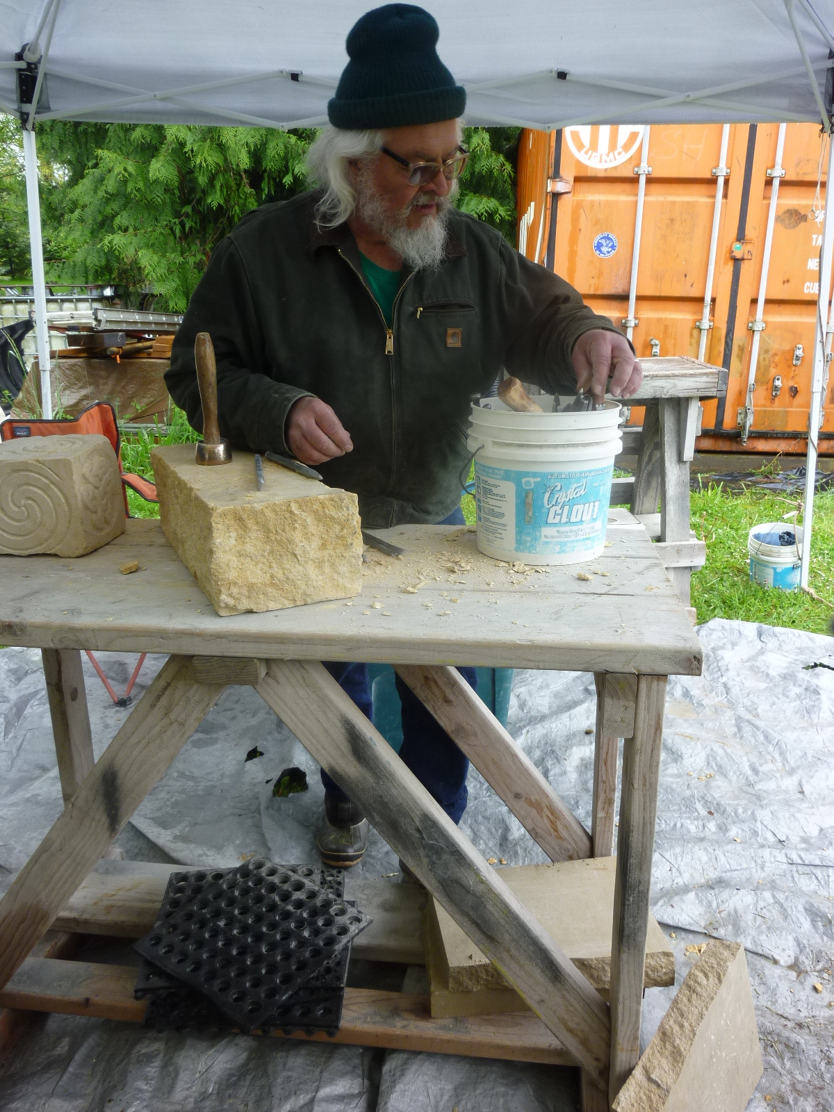 Wearing the tall hat of intelligence, Tracy Powell makes a chisel selection to demonstrate the hand cutting of Texas limestone. 