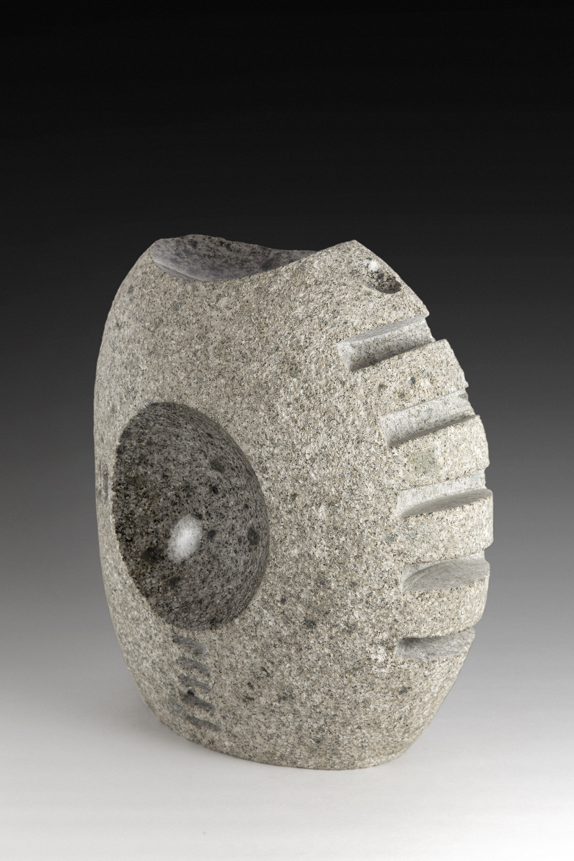 “Rigid”, granite, 13” tall, 2013 I wanted to make something organic, but mechanical. Cog wheel, gear, tracks…that kind of things overlapping with the very organic shape and texture of the river rock intrigued me.