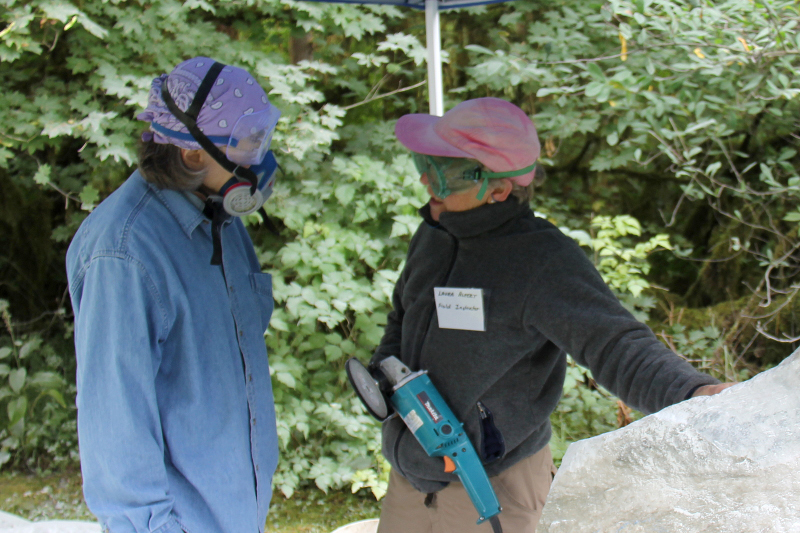 The red hatted Laura Alpert passes on a little wisdom to the blue bandanaed Christine Page  