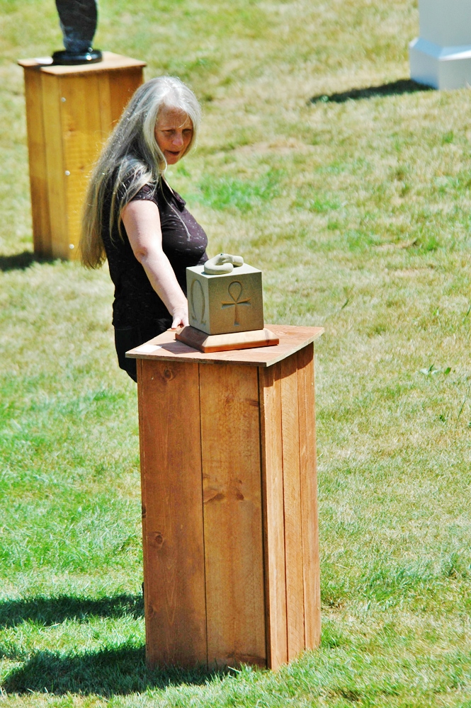 Libby McGeorge spending a moment with her sculpture purchase from Ed Salerno